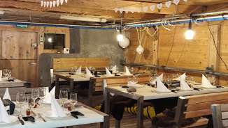 Rustic barn from the inside, covered with tables and place settings