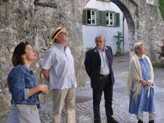 Actors in the small town of Maienfeld on a scenic tour of the town