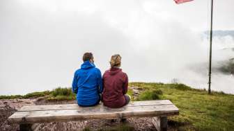 Couple sitting on a bench in the fog