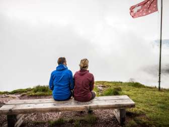 Couple sitting on a bench in the fog
